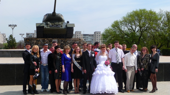 Wedding portrait with a tank in the background, very romantic setting in Tiraspol