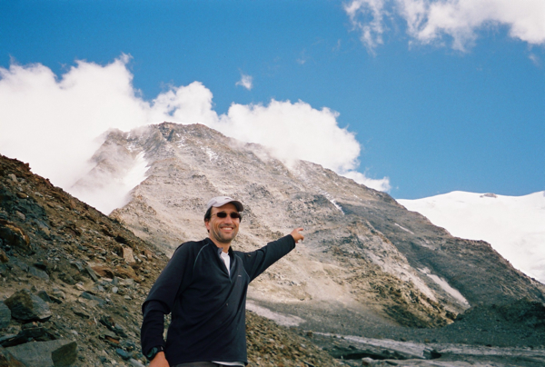 Francis Tapon is pointing to Le Grand Couloir on Mont Blanc. You have to climb this while listening to rocks fall nearby. If you are unlucky, a rock will fall on your head. Just hope your helmet protects you just enough to live with only a little brain damage.