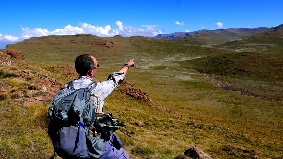 Pointing to the tallest mountain in South Africa on the Drakensberg Traverse