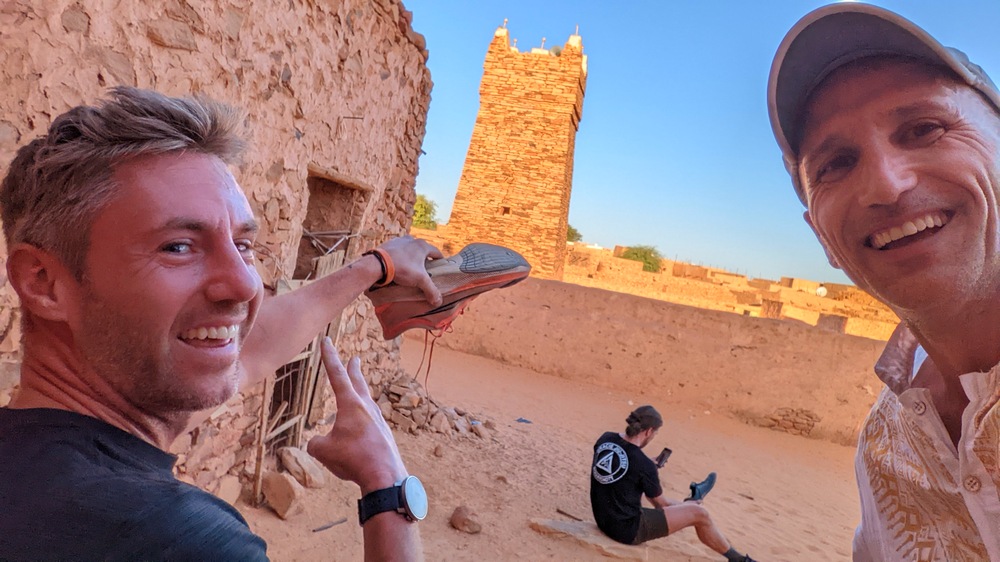 Johnny Ward and Francis Tapon in Mauritania emptying sand from a shoe