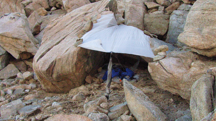 On the crest of the Wind River Range there are no trees, so I used my umbrella as an anchor for my tarp. In this camping spot I was stuck between a rock and hard place. :)