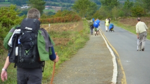 The man on the right had an awkward gait because he had pain in his kidneys, while another pilgrim enjoyed the roads because he could roll a cart instead of hauling a backpack.